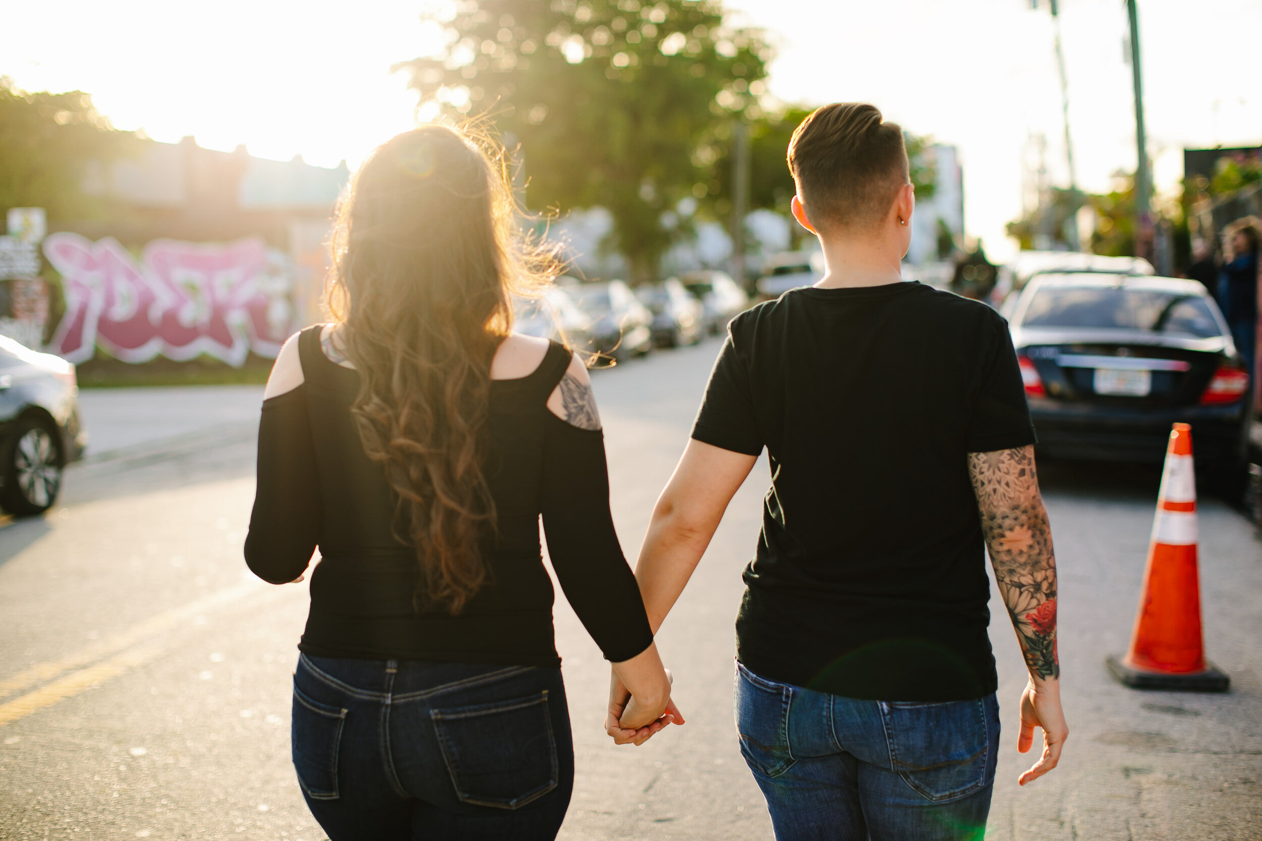 Lesbian-couple-holding-hands-sunset-wynwood-tiny-house-photo