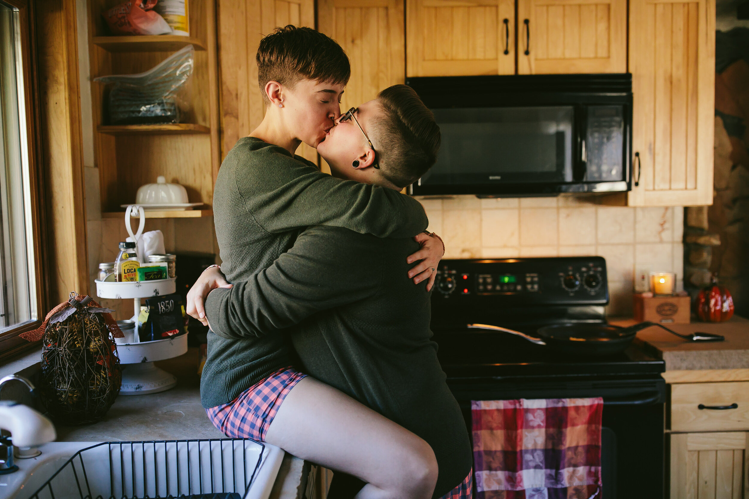 Queer Couple Kissing in cabin kitchen before eloping
