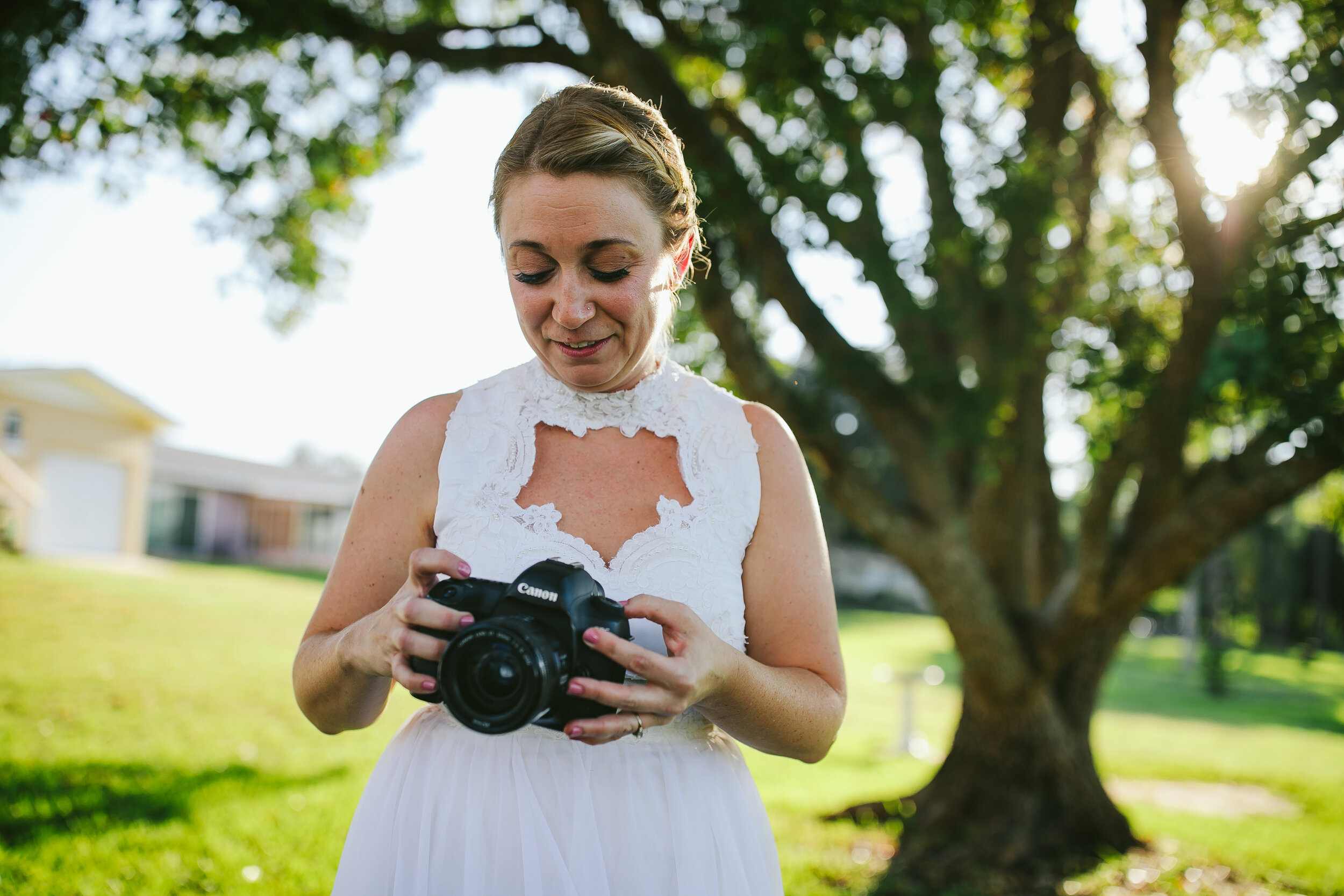 Beautiful Backyard Wedding Photographer Bride Holding Her Camera