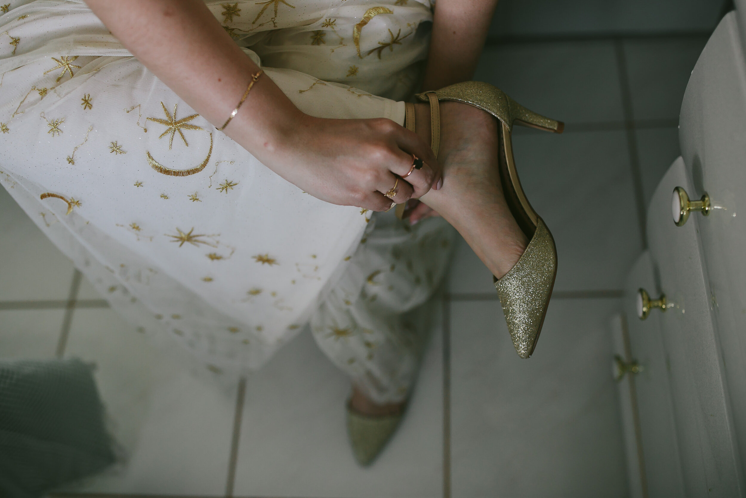 Bride-Putting-On-Gold-Wedding-Shoes-Homestead-Backyard-Elopement