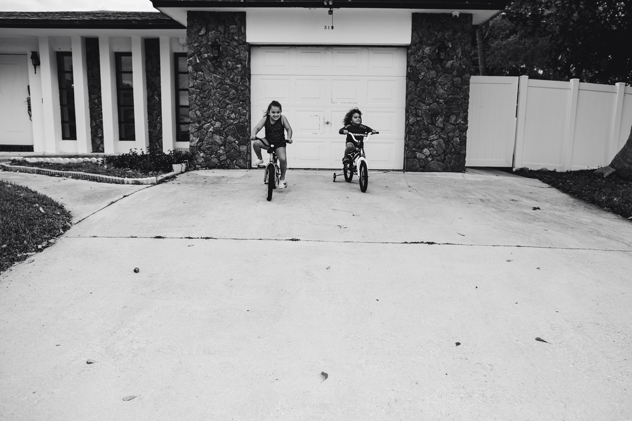 Brother-Sister-Riding-Bikes-Driveway-Florida-Family-Photographer