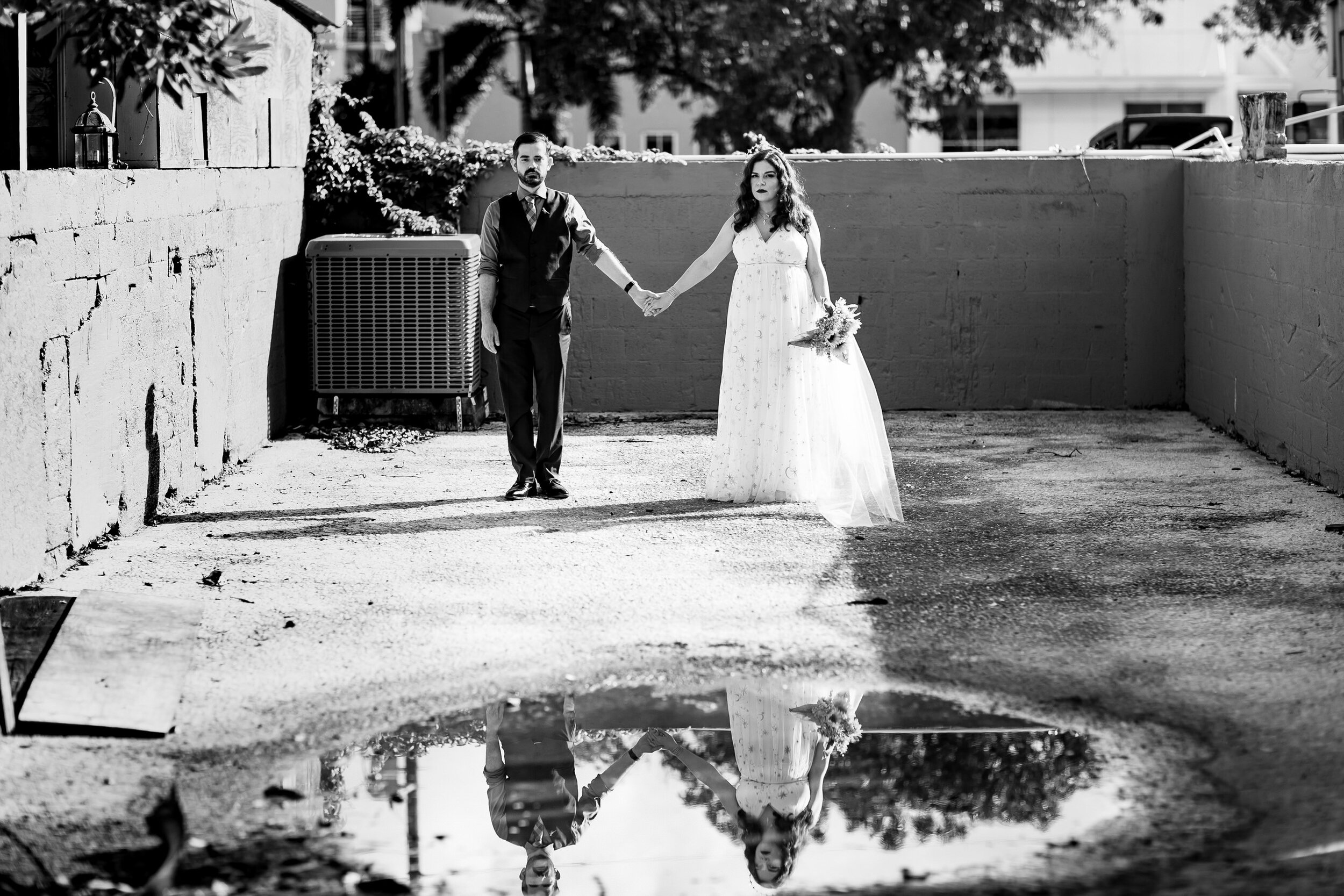Florida-Non-Traditional-Wedding-Photography-Bride-Groom-Holding-Hands-Urban-Puddle-Reflection