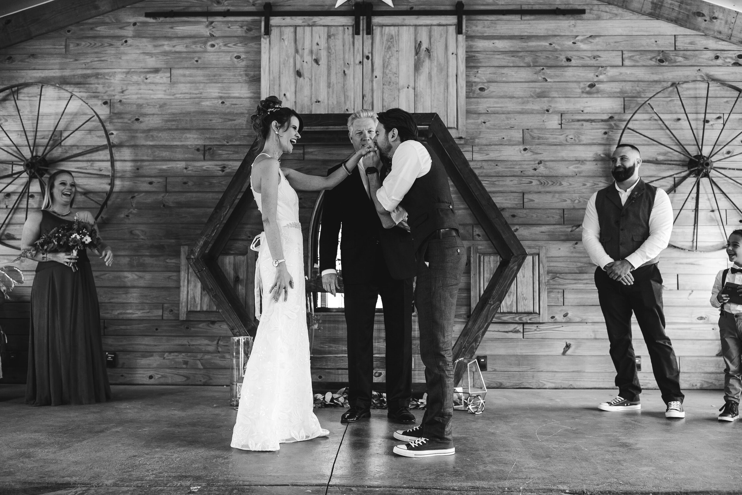 Groom-Kissing-Brides-Hand-Wedding-Ceremony-Tiny-House-Photo
