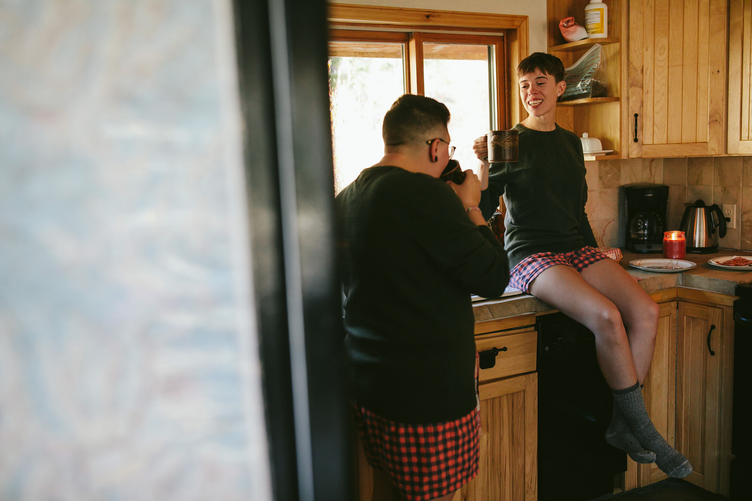 Gunnison Colorado LGBTQ Elopement Brides Drinking Coffee in their Cabin