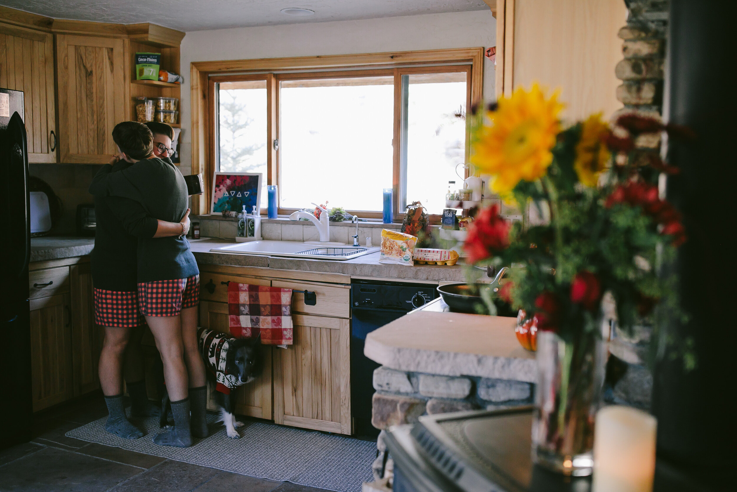 LGBTQ Couple Hugging in Airbnb Kitchen before Elopement Gunnison Colorado