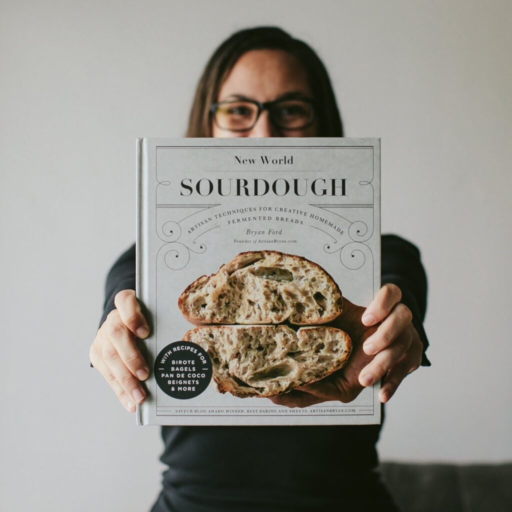 Stephanie Warga of Tiny House Photo holding New World Sourdough Cookbook