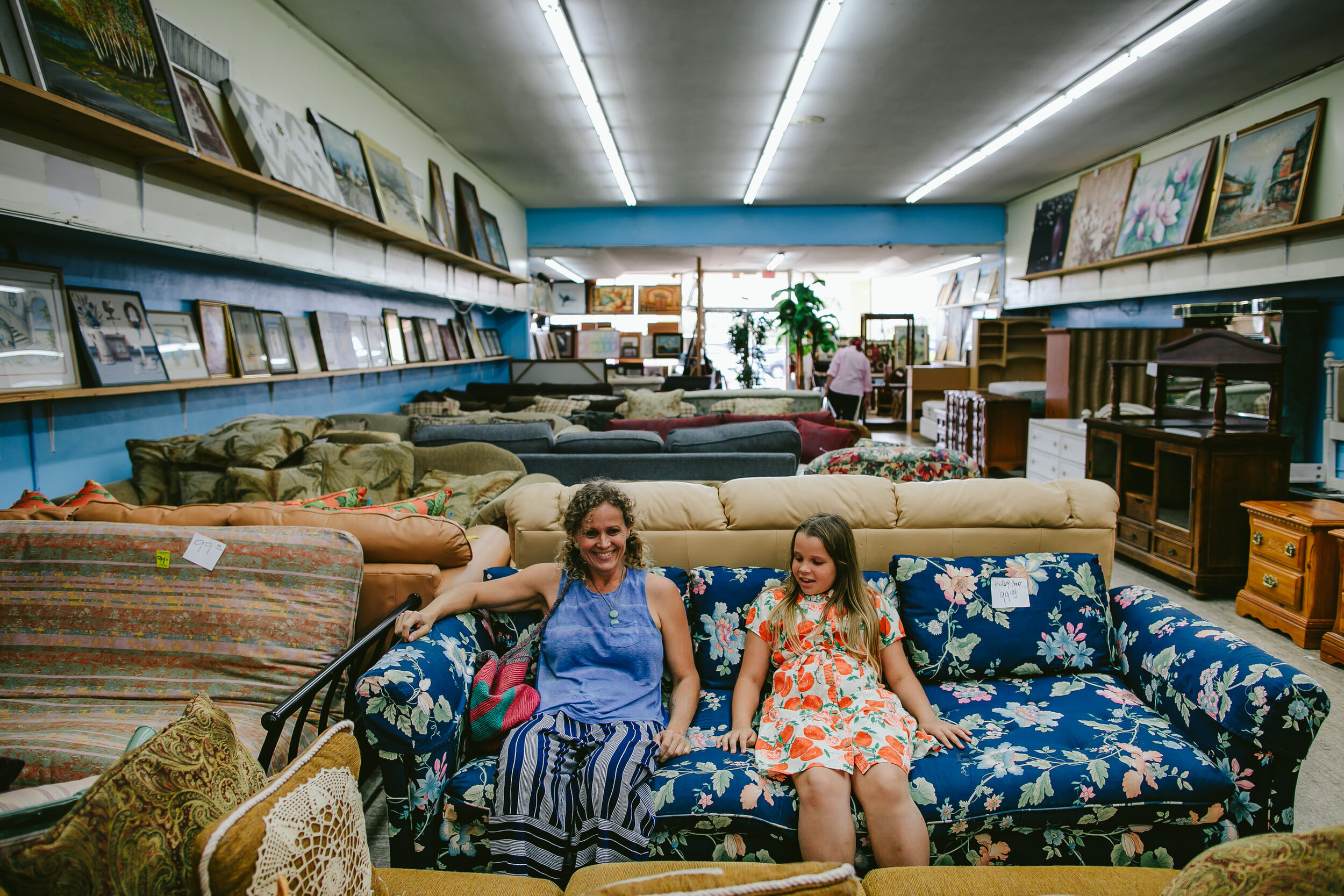 Mother-Daughter-Sitting-On-Couches-Thrift-Store
