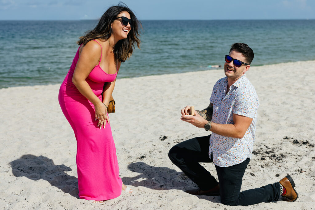 Couple full of joy and laughter after Beach Proposal