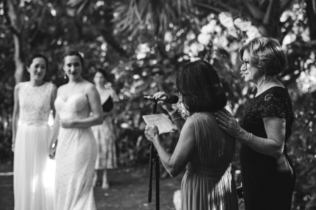 Black and White image of Mothers of Brides speaking during their Destination Wedding Ceremony