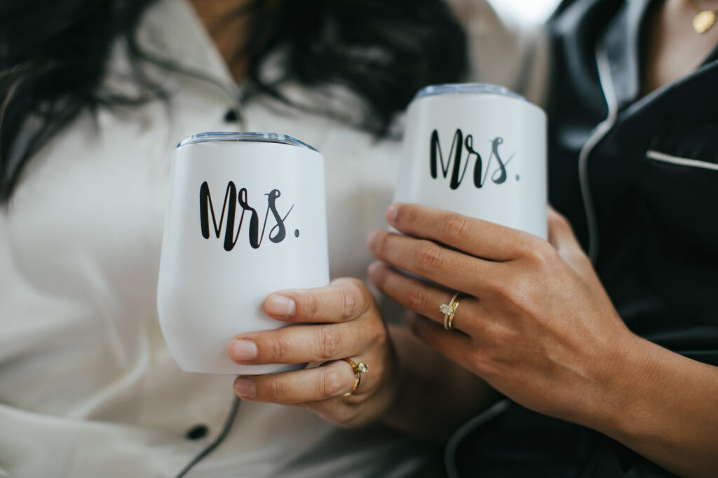 Two Brides holding Mrs Coffee Mugs at their Colorado Morning Elopement