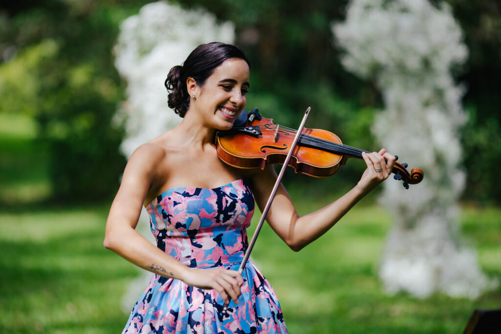 Dani the Violinist plays for guests as they arrive at this Sentimental Garden Wedding in South Florida