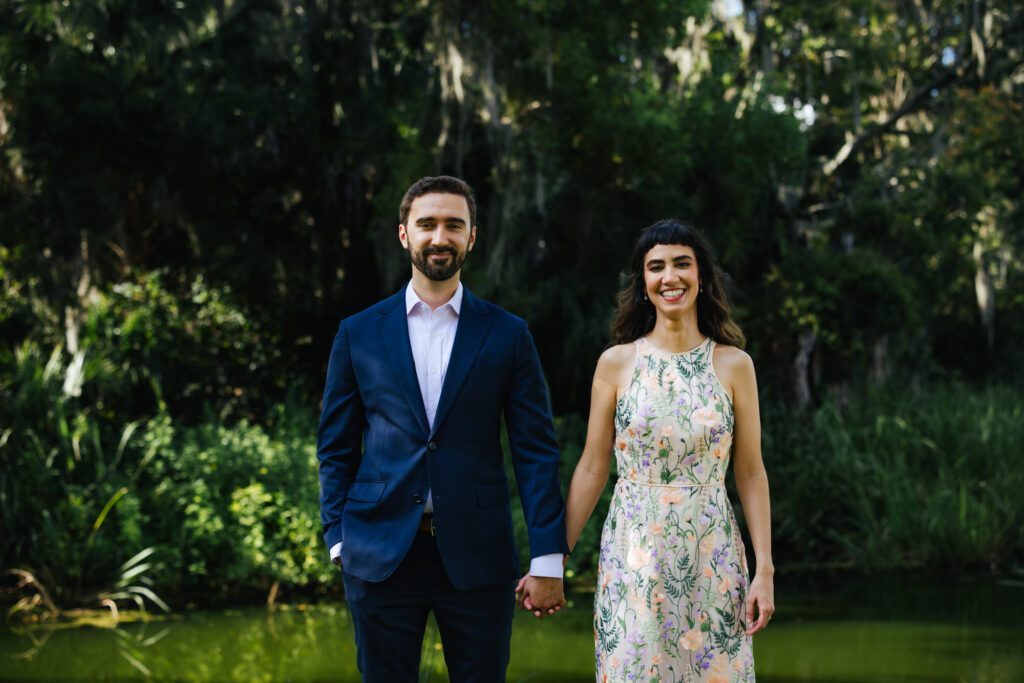 Couple holding hands at Buaghman Center in Gainesville for their Engagement Photos