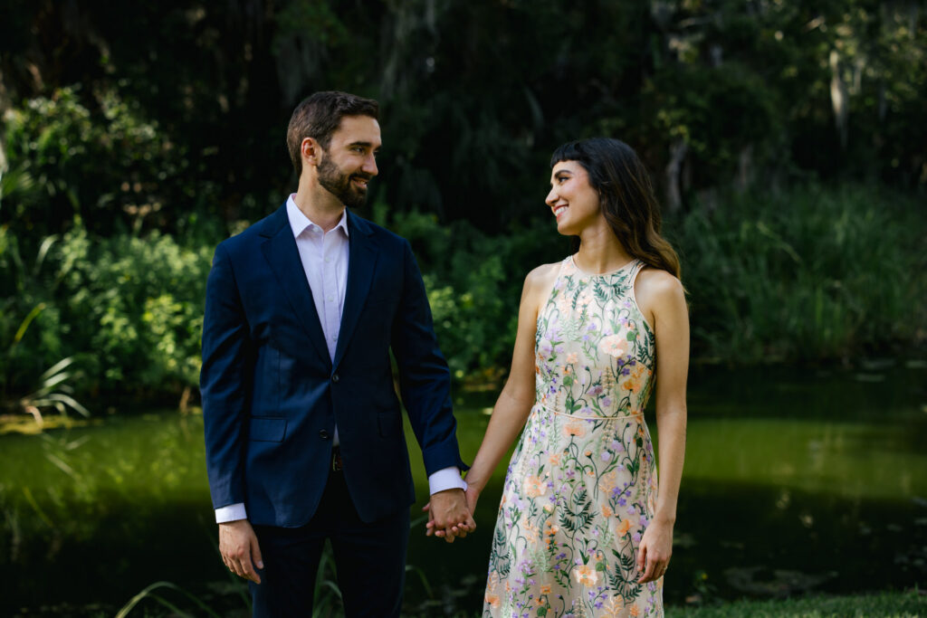 Couple holding hands at Buaghman Center in Gainesville for their Engagement Photos
